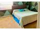 Bedroom with teal walls and patterned bedding at 3709 Feather Dr, Lakeland, FL 33812
