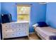Small bedroom with blue walls and a full-size bed at 3709 Feather Dr, Lakeland, FL 33812