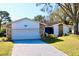 Charming one-story home with a large front yard and attached garage at 3709 Feather Dr, Lakeland, FL 33812
