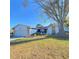 Renovated single story home with a landscaped yard and large tree at 3709 Feather Dr, Lakeland, FL 33812