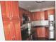 Modern kitchen with stainless steel appliances and wood cabinets at 3709 Feather Dr, Lakeland, FL 33812