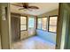 Bright sunroom with wood-look tile floor and ceiling fan at 3709 Feather Dr, Lakeland, FL 33812