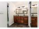 Bathroom featuring a double vanity with granite countertops and a tile floor at 4617 S Devon Ave, Lakeland, FL 33813