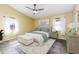 Bright main bedroom with a ceiling fan, neutral colors, and a comfortable upholstered bed at 4617 S Devon Ave, Lakeland, FL 33813