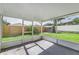 Cozy screened-in porch with a view of the backyard and surrounding greenery at 4617 S Devon Ave, Lakeland, FL 33813