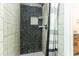 Beautifully tiled shower with a pebble accent wall and a convenient niche at 4617 S Devon Ave, Lakeland, FL 33813