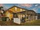 Backyard view of home and screened-in pool at 531 Las Fuentes Dr, Kissimmee, FL 34746