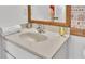 Bathroom featuring a clean white vanity with an undermount sink and decorative mirror at 531 Las Fuentes Dr, Kissimmee, FL 34746