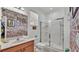 Bathroom with walk-in shower, brick-accent wall, and wooden vanity at 531 Las Fuentes Dr, Kissimmee, FL 34746