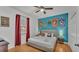 Bedroom with king-size bed, Hogwarts house banners, and wood floors at 531 Las Fuentes Dr, Kissimmee, FL 34746