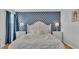 Bedroom with queen-size bed and blue decor at 531 Las Fuentes Dr, Kissimmee, FL 34746
