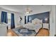 Main bedroom with a king-size bed and blue accents at 531 Las Fuentes Dr, Kissimmee, FL 34746
