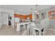 Kitchen with granite countertops, wooden cabinets, island, and breakfast bar at 531 Las Fuentes Dr, Kissimmee, FL 34746