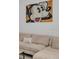 Comfortable living room featuring a plush sectional sofa and unique Mickey Mouse wall art at 531 Las Fuentes Dr, Kissimmee, FL 34746