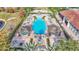 Aerial view of the community pool with lounge chairs and lush landscaping at 531 Las Fuentes Dr, Kissimmee, FL 34746