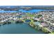 Expansive aerial view of a residential area with homes surrounding a serene lake and community amenities at 535 Narrow Pond Rd, Polk City, FL 33868