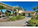 The entrance welcomes you with palms, landscaping and a charming covered entryway at 535 Narrow Pond Rd, Polk City, FL 33868