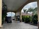 Covered entryway featuring stone accents and mature landscaping at 535 Narrow Pond Rd, Polk City, FL 33868