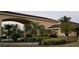 Welcoming entrance with lush landscaping and a covered drive at 535 Narrow Pond Rd, Polk City, FL 33868