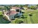 Yard with mature landscaping, privacy hedge, and covered parking with an outside seating area at 535 Narrow Pond Rd, Polk City, FL 33868