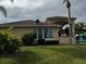 Back yard with a covered patio, well maintained grass, and a privacy hedge at 535 Narrow Pond Rd, Polk City, FL 33868