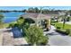 Aerial view of well landscaped yard and covered parking area on lakefront lot at 535 Narrow Pond Rd, Polk City, FL 33868