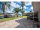 Scenic backyard featuring a large patio, perfect for enjoying outdoor living with waterfront views and a private dock at 6029 Avocado Dr, Indian Lake Estates, FL 33855
