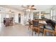 Bright breakfast nook features a dining table with booth seating and ample natural light from the surrounding windows at 6029 Avocado Dr, Indian Lake Estates, FL 33855