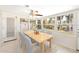 Sunlit dining area with tile floors, a ceiling fan, and views of the outdoors through multiple windows at 6029 Avocado Dr, Indian Lake Estates, FL 33855