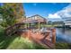 Wooden dock with a seating area overlooking the serene waterfront at 6029 Avocado Dr, Indian Lake Estates, FL 33855