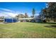 Charming home featuring a well-maintained front yard, carport, and attached garage at 6029 Avocado Dr, Indian Lake Estates, FL 33855