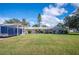 Charming home featuring a well-maintained front yard, carport, and attached garage at 6029 Avocado Dr, Indian Lake Estates, FL 33855
