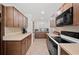 Spacious kitchen showcasing tiled floors, countertops and stainless steel appliances, perfect for cooking and entertaining at 6029 Avocado Dr, Indian Lake Estates, FL 33855
