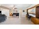 The living room features tiled floors, a built-in desk and shelving area, and comfortable seating arrangements at 6029 Avocado Dr, Indian Lake Estates, FL 33855