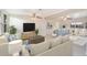 Inviting open-concept living area with ceiling fans, comfortable seating arrangements and ample natural light at 6029 Avocado Dr, Indian Lake Estates, FL 33855