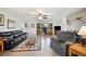 Spacious living room with tiled floors, brick fireplace, and seamless transition to a built-in desk area at 6029 Avocado Dr, Indian Lake Estates, FL 33855