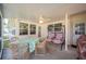 Inviting screened porch featuring a dining table and a charming porch swing, perfect for relaxation at 6029 Avocado Dr, Indian Lake Estates, FL 33855