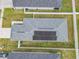 Aerial view of a home with solar panels, fenced yard, and a concrete driveway at 1354 Mezzavalle Way, Auburndale, FL 33823