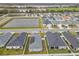 Community aerial showcasing neighborhood pond, landscaping, and well-spaced homes at 1354 Mezzavalle Way, Auburndale, FL 33823