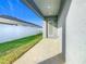 A covered back porch and well-manicured yard provide outdoor living space at 1354 Mezzavalle Way, Auburndale, FL 33823