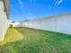 A large, green backyard is enclosed by a white vinyl privacy fence at 1354 Mezzavalle Way, Auburndale, FL 33823