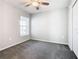 Comfortable bedroom features a ceiling fan, neutral walls, and soft carpeting at 1354 Mezzavalle Way, Auburndale, FL 33823