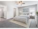 Cozy bedroom with a ceiling fan, plush carpet, and natural light from the window at 1354 Mezzavalle Way, Auburndale, FL 33823