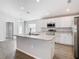 Bright kitchen featuring a central island with a sink and modern appliances at 1354 Mezzavalle Way, Auburndale, FL 33823