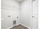 Functional laundry room featuring utility connections and a storage shelf at 1354 Mezzavalle Way, Auburndale, FL 33823