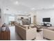 Open-concept living space with modern finishes connecting the kitchen, dining, and living areas at 1354 Mezzavalle Way, Auburndale, FL 33823