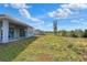 Spacious backyard with grassy area and partial view of the house at 2116 Sarah Way, Mulberry, FL 33860