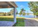 Covered patio overlooks a pond with lush landscaping at 2116 Sarah Way, Mulberry, FL 33860