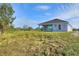 House's back elevation, backyard, and surrounding landscape at 2116 Sarah Way, Mulberry, FL 33860