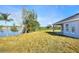 House's back elevation and large backyard with pond view at 2116 Sarah Way, Mulberry, FL 33860